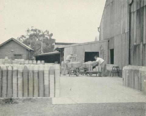 Stacking pots ready for firing, Nunawading, 1956